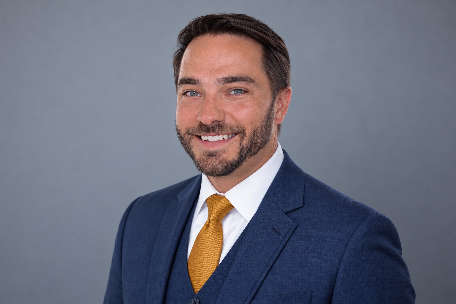 Jonathan Paschal smiling in a navy suit